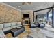 An outdoor living space with a stone fireplace, comfortable seating, TV, and a built-in grill at 829 Big Horn Holw, Suwanee, GA 30024