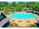 Community pool view showcases a large swimming area, sun loungers, and a gazebo for shade at 829 Big Horn Holw, Suwanee, GA 30024