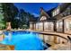 Inviting backyard pool with stone accents and ambient lighting for evening enjoyment at 829 Big Horn Holw, Suwanee, GA 30024