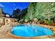 Beautiful pool area with stone waterfall features and lush landscaping at night at 829 Big Horn Holw, Suwanee, GA 30024