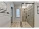 Walk in shower features a glass door and tiled walls accented with decorative tile at 829 Big Horn Holw, Suwanee, GA 30024