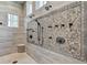 This primary bathroom features a luxurious walk-in shower with intricate tile design at 829 Big Horn Holw, Suwanee, GA 30024