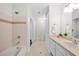 Well-lit bathroom featuring tiled walls, vanity, and a separate toilet area at 1101 Juniper Ne St # 1504, Atlanta, GA 30309