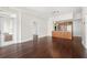 Open-concept living space with hardwood floors, kitchen view, and access to the balcony at 1101 Juniper Ne St # 1504, Atlanta, GA 30309