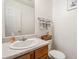 Powder room featuring marble countertop and bright white vanity at 1644 Cutters Mill Dr, Lithonia, GA 30058