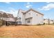 Two-story home with a gray exterior, a dark wood deck, and a well-maintained lawn at 1644 Cutters Mill Dr, Lithonia, GA 30058