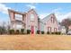 Charming two-story brick home featuring a bright red front door and well-maintained landscaping at 1644 Cutters Mill Dr, Lithonia, GA 30058