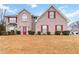 Two-story brick home with a red front door, shutters, and a well-manicured lawn at 1644 Cutters Mill Dr, Lithonia, GA 30058