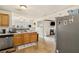 Open kitchen featuring tile floors, wood cabinets and stainless steel dishwasher at 1644 Cutters Mill Dr, Lithonia, GA 30058