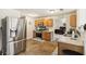 Modern kitchen with stainless steel appliances, light wood cabinets, and tiled floors at 1644 Cutters Mill Dr, Lithonia, GA 30058