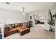 Inviting living room featuring a sectional sofa, neutral carpet, and plenty of natural light at 1644 Cutters Mill Dr, Lithonia, GA 30058