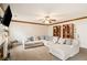 Spacious living room with a large sectional sofa, ceiling fan, and built-in bookshelves at 1644 Cutters Mill Dr, Lithonia, GA 30058
