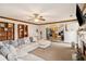 Open-concept living room featuring a cozy fireplace, large sectional, and direct kitchen access at 1644 Cutters Mill Dr, Lithonia, GA 30058