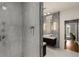 Modern bathroom with walk-in shower and floating vanity, featuring stylish lighting and a neutral color palette at 2009 Kensington Green Se Dr, Smyrna, GA 30080
