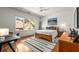 Bright bedroom with natural light, hardwood floors, modern decor, and a dedicated desk space at 2009 Kensington Green Se Dr, Smyrna, GA 30080