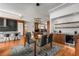 Open concept dining area featuring modern lighting, a glass table, and convenient access to the kitchen at 2009 Kensington Green Se Dr, Smyrna, GA 30080
