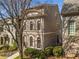 Elegant townhome with arched windows, brick detailing, and well-maintained grounds at 2009 Kensington Green Se Dr, Smyrna, GA 30080