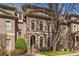 Elegant brick home with arched windows and a well-maintained front yard, showing classic architectural details at 2009 Kensington Green Se Dr, Smyrna, GA 30080