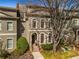 Charming townhouse featuring arched windows, brick facade, and manicured landscaping at 2009 Kensington Green Se Dr, Smyrna, GA 30080