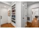 Bright hallway featuring hardwood floors and a built-in bookshelf for displaying books and decor at 2009 Kensington Green Se Dr, Smyrna, GA 30080