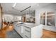 Open-concept kitchen featuring a large island, modern cabinets, and an adjacent living area at 2009 Kensington Green Se Dr, Smyrna, GA 30080