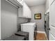 Functional laundry room featuring a front-load washer and dryer, ample storage cabinets, and practical design elements at 2009 Kensington Green Se Dr, Smyrna, GA 30080