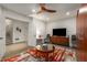 Cozy living room features a modern ceiling fan, plush rug, and a stylish entertainment center at 2009 Kensington Green Se Dr, Smyrna, GA 30080