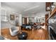 Open-concept living area featuring hardwood floors, stylish furniture, and a seamless flow to the kitchen at 2009 Kensington Green Se Dr, Smyrna, GA 30080
