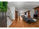 Open concept living space with hardwood floors, modern decor, and seamless flow to the kitchen and dining areas at 2009 Kensington Green Se Dr, Smyrna, GA 30080