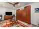 Cozy living space featuring built-in storage, a ceiling fan, and a TV, creating a comfortable and inviting atmosphere at 2009 Kensington Green Se Dr, Smyrna, GA 30080