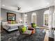 Spacious main bedroom with a large bed, stylish seating, and abundant natural light from arched windows at 2009 Kensington Green Se Dr, Smyrna, GA 30080