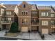 Rear view of townhomes showcasing brick exteriors, balconies, and two-car garages at 2009 Kensington Green Se Dr, Smyrna, GA 30080