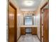 Hallway featuring a vanity area with drawers and a mirror, with doors on either side, for convenience at 360 W Spalding Dr, Atlanta, GA 30328