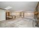 Open living room with stone fireplace, wood trim, skylights and neutral carpeting at 360 W Spalding Dr, Atlanta, GA 30328