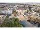 Aerial view of a neighborhood with a pond, playground, and homes in a beautiful community at 3810 Branch Bluff Ln, Cumming, GA 30040
