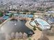 Aerial view showcases community amenities: pool, tennis courts, playground, and clubhouse at 3810 Branch Bluff Ln, Cumming, GA 30040