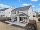 This backyard offers a covered patio with ample space for outdoor seating and entertaining at 3810 Branch Bluff Ln, Cumming, GA 30040