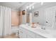 Bright bathroom featuring double vanity, shower-tub combo, and neutral color palette at 3810 Branch Bluff Ln, Cumming, GA 30040