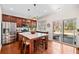 Beautiful kitchen featuring wood cabinets, stainless steel appliances, and a large center island with sliding door to backyard at 3810 Branch Bluff Ln, Cumming, GA 30040