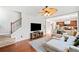 Inviting living room featuring hardwood floors, stairs, and an open view of the adjacent kitchen at 3810 Branch Bluff Ln, Cumming, GA 30040