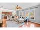 Spacious living room with hardwood floors, a ceiling fan, and an open layout to the kitchen at 3810 Branch Bluff Ln, Cumming, GA 30040