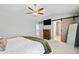 Main bedroom features barn door to bath, ceiling fan, and a calming, neutral color palette at 3810 Branch Bluff Ln, Cumming, GA 30040