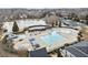 A close aerial view of a community pool featuring a large pool, a slide, and a shallow splash pool near lake and tennis courts at 3810 Branch Bluff Ln, Cumming, GA 30040