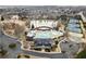 Aerial view of a community pool area with a large pool, tennis courts, and a clubhouse, surrounded by trees and houses at 3810 Branch Bluff Ln, Cumming, GA 30040