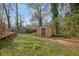 Spacious backyard with utility shed and partial fencing, offering privacy and storage at 4570 Nantucket Sw Dr, Lilburn, GA 30047