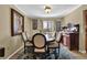 Traditional dining room featuring an oval wood table, six chairs, and a stylish peacock-themed rug at 4570 Nantucket Sw Dr, Lilburn, GA 30047