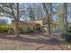 Charming home with a red door, lush landscaping, and a welcoming front porch at 4570 Nantucket Sw Dr, Lilburn, GA 30047