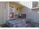 Cozy front porch with stone steps, bench, and decor, creating an inviting entry at 4570 Nantucket Sw Dr, Lilburn, GA 30047