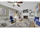Comfortable living room with built-in shelving, a fireplace, and a ceiling fan at 4570 Nantucket Sw Dr, Lilburn, GA 30047