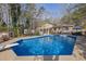 Sparkling swimming pool with diving board and a backyard oasis, perfect for summer fun and relaxation at 4570 Nantucket Sw Dr, Lilburn, GA 30047
